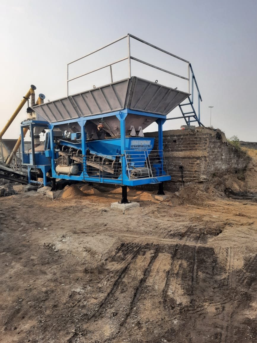 Newly painted blue and white concrete batching plant set up at a site