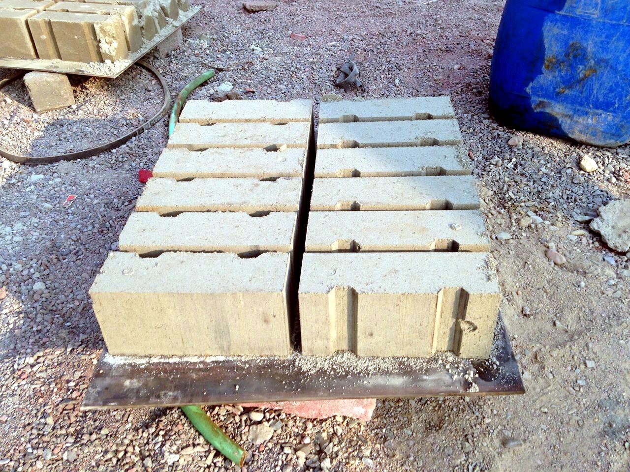 Machine-pressed fly ash bricks on production pallets
