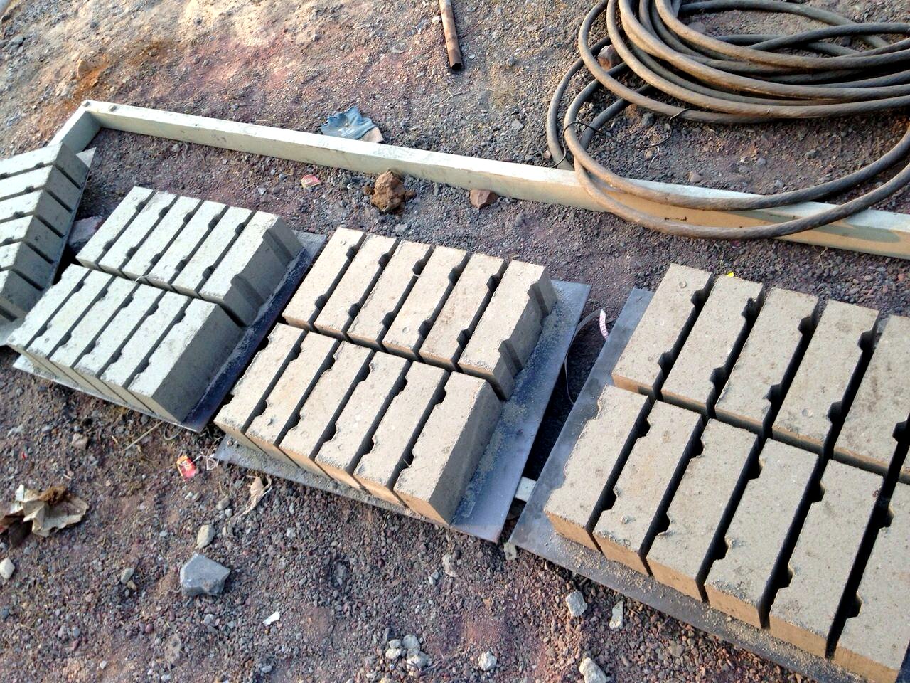 Freshly pressed bricks on pallets at an onsite production yard