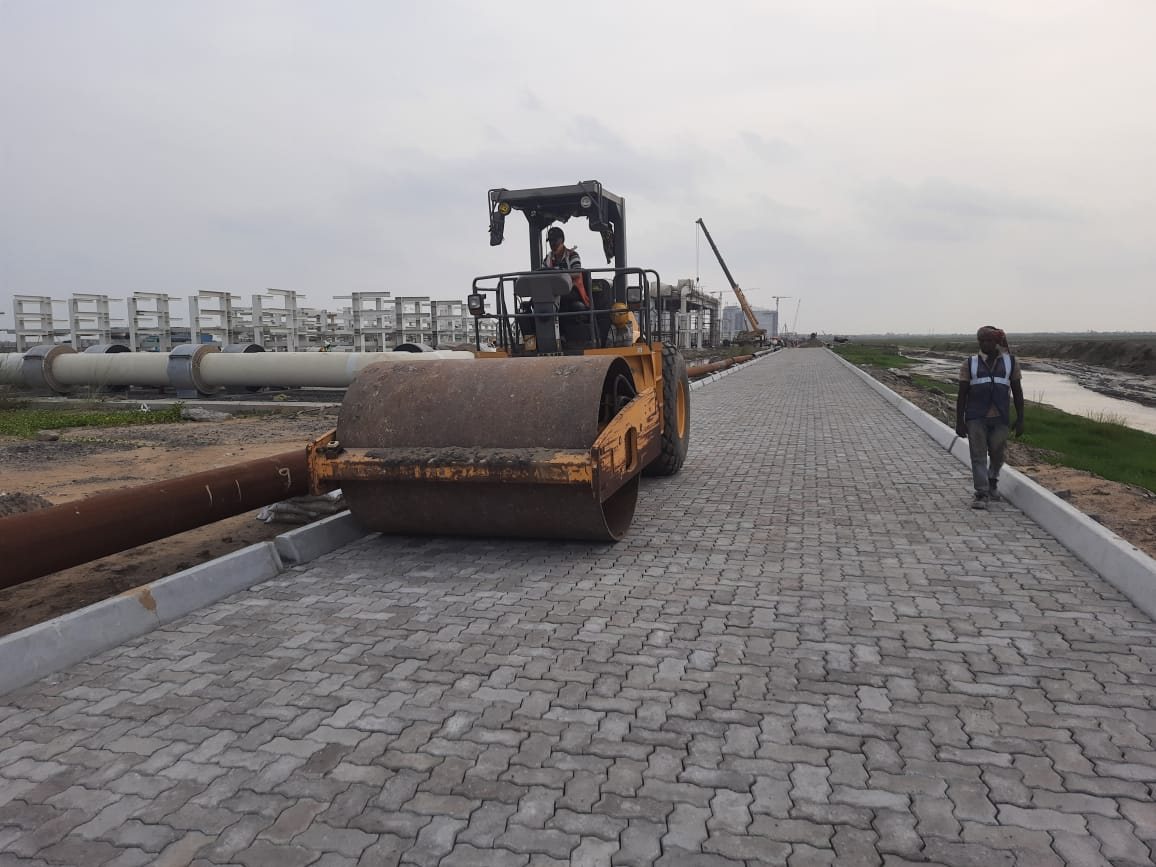 Vibratory roller working over a finished M-50 unipaver road at Dhamra Port
