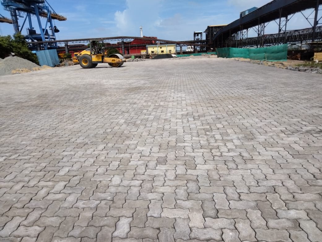 Finished paver pavement in the steel stackyard at Dhamra Port, with conveyors behind