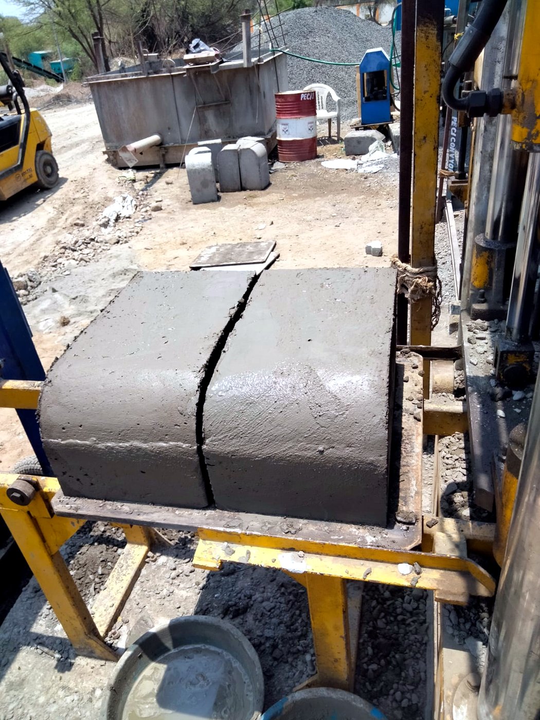 Freshly pressed kerb blocks on a mobile precast plant at site