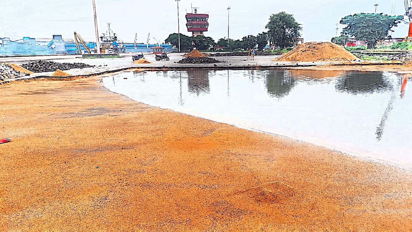 Before repair at NMPA — waterlogged paver yard with standing water across a sunken area