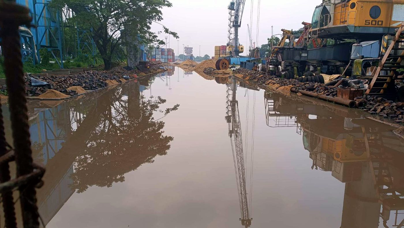 Before repair at NMPA — flooded roadway between cranes with water ponding over the full width