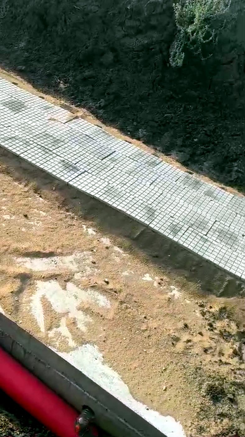 Chequered tiles laid as protective covers over a cable route